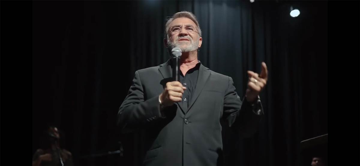 man with beard holding microphone